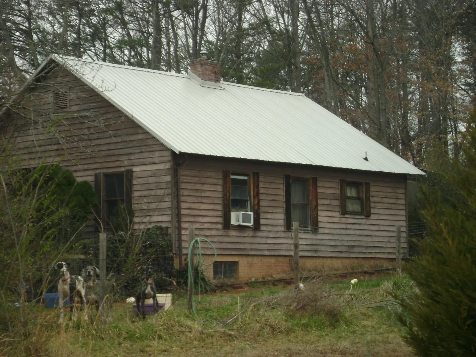 White metal roof on an old wood sided farmhouse, from a Metal Roof Installation job in Brighton